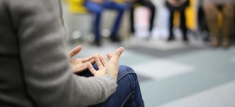 Person attenting addiction meeting.