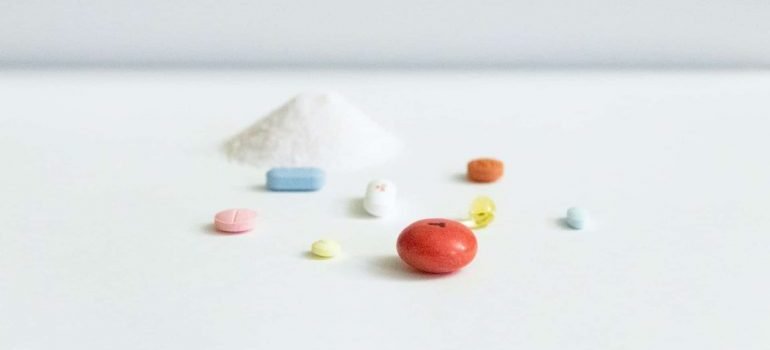 Drugs in various forms are arranged on a table.
