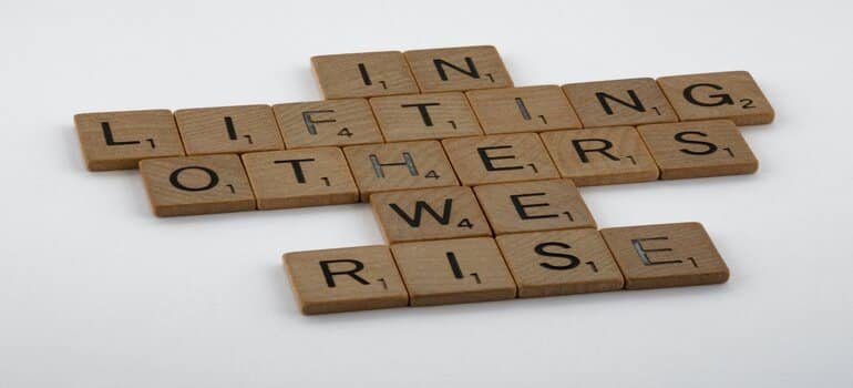wooden letters reading in lifting others we rise which is what you should expect in a partial hospitalization program
