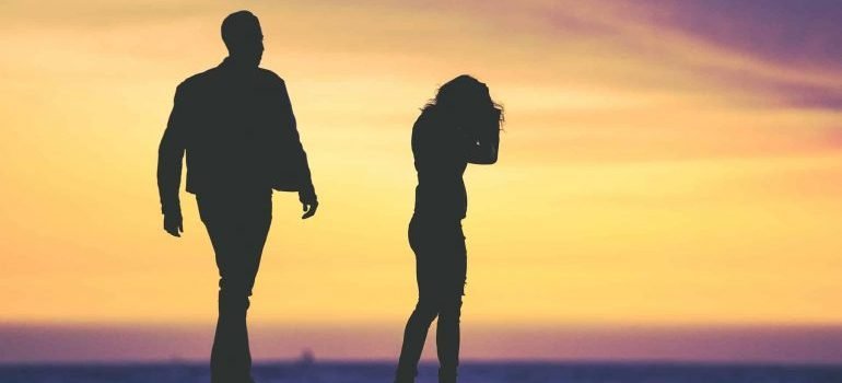 A silhouette of a couple fighting during sunset.
