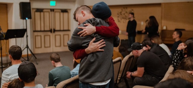 Two people hugging during a support group therapy session