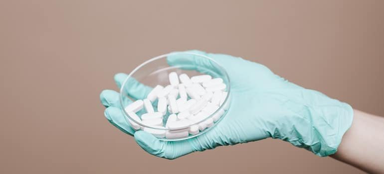 A hand holding drugs