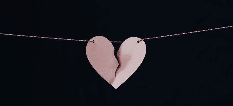 A broken paper heart on a piece of string.