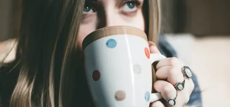 A young woman holding her cup