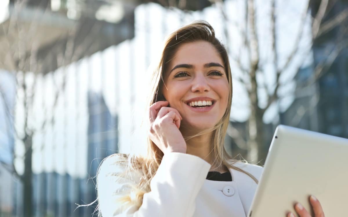 a happy woman talking on her phone