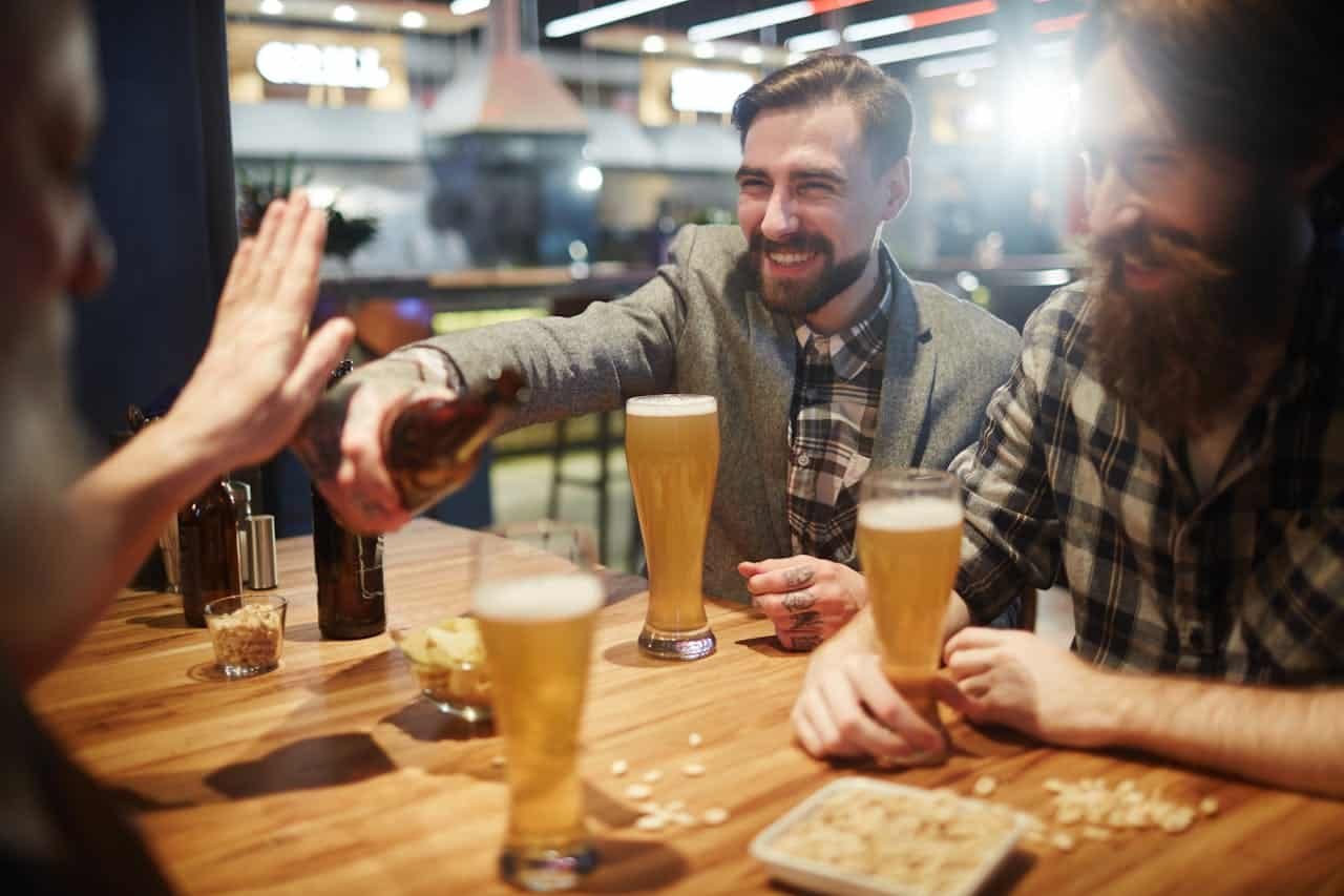Woman refusing a drink while with her friends.