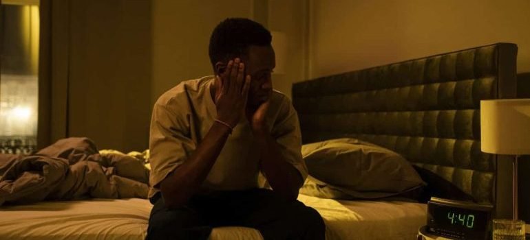 A Man Sitting on a Bed and thinking about his Demerol addiction