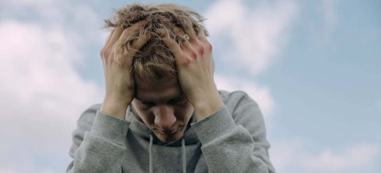 man with hands on his head