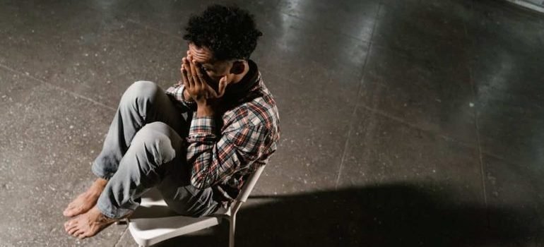 A Frightened Man Sitting Alone on a Chair