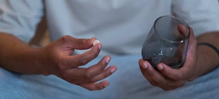 Person Taking a Pill and thinking about Demerol addiction