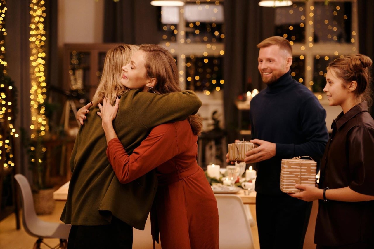 Two woman hugging during a family gathering and building a strong support system while battling depression