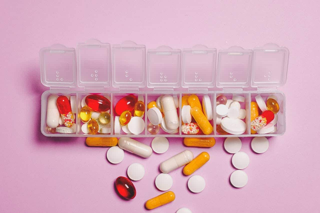 a plastic box with pills spilling out of it