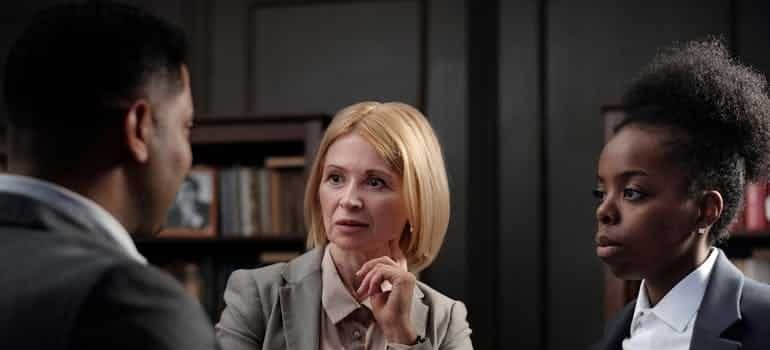 three people talking