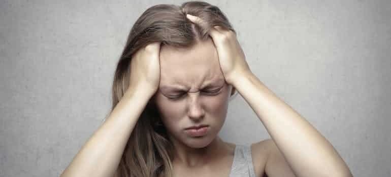 woman holding her head