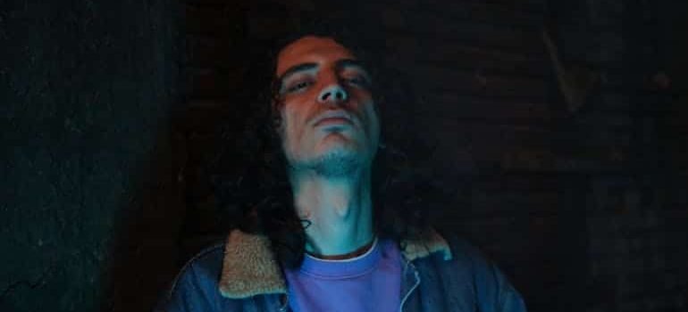lonely man leaning on a wall